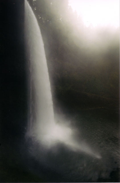 [Long, tall photograph of South Falls in which the falls is white against a black background]